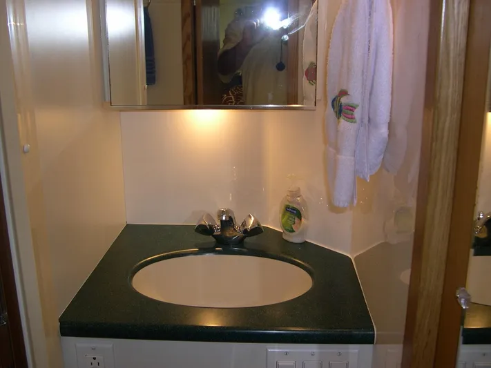 "salty Dog" Yacht Photos Pics Compact yacht bathroom with sink, mirror, and towel in Tiara Yachts 4100 Open, 2000 model.