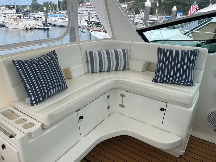 "salty Dog" Yacht Photos Pics Luxurious seating area on a 2000 Tiara Yachts 4100 Open, featuring striped cushions.