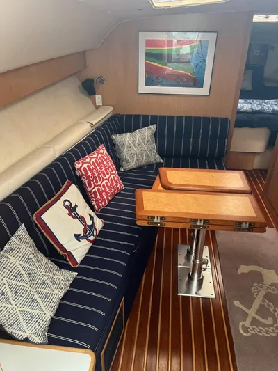 "salty Dog" Yacht Photos Pics Interior of 2000 Tiara Yachts 4100 Open with striped seating and nautical decor.