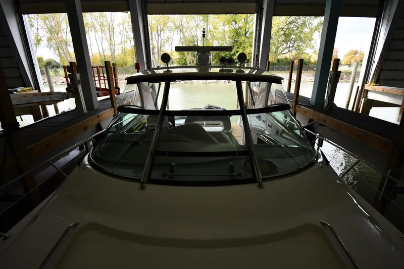  Yacht Photos Pics 2001 Sea Ray 540 Sundancer docked in a covered marina with scenic background.