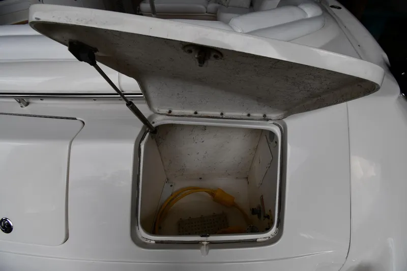  Yacht Photos Pics Open storage compartment on 2001 Sea Ray 540 Sundancer boat, showing interior and yellow cable.
