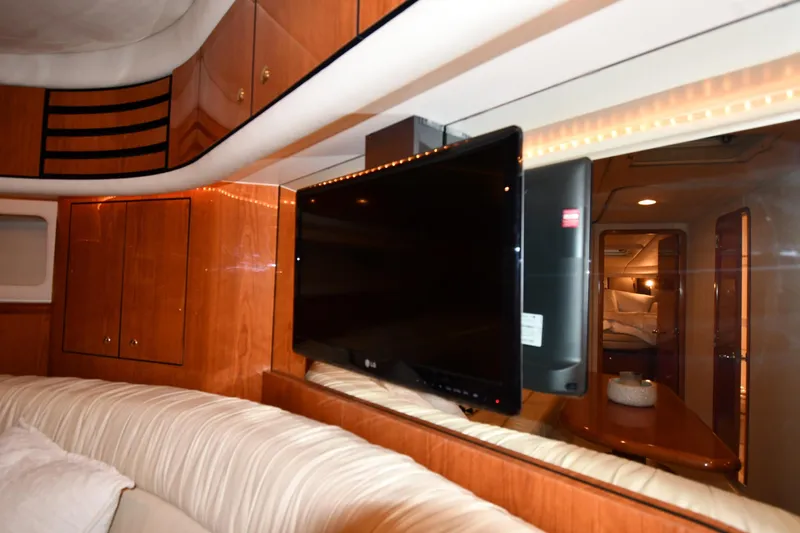  Yacht Photos Pics Luxurious interior of 2001 Sea Ray 540 Sundancer yacht with TV and wood cabinetry.