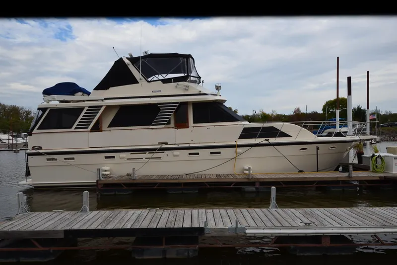  Yacht Photos Pics 1990 Jefferson 52 Marquessa ED yacht docked at marina under cloudy sky.