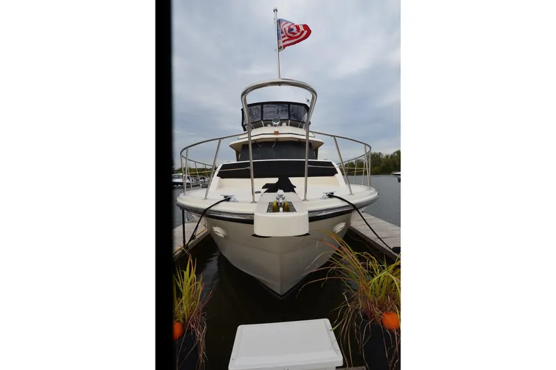  Yacht Photos Pics 1990 Jefferson 52 Marquessa ED yacht docked with American flag.