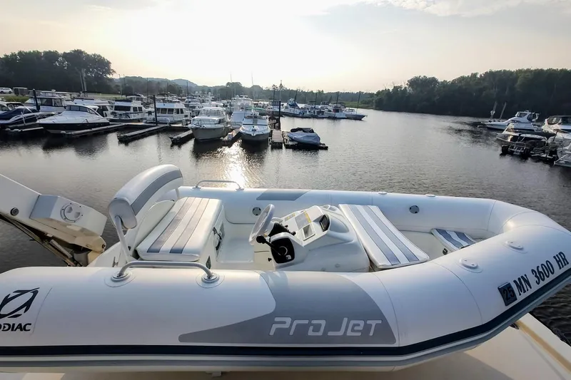  Yacht Photos Pics Inflatable boat on Jefferson 52 Marquessa ED, 1990, docked at marina with other boats.