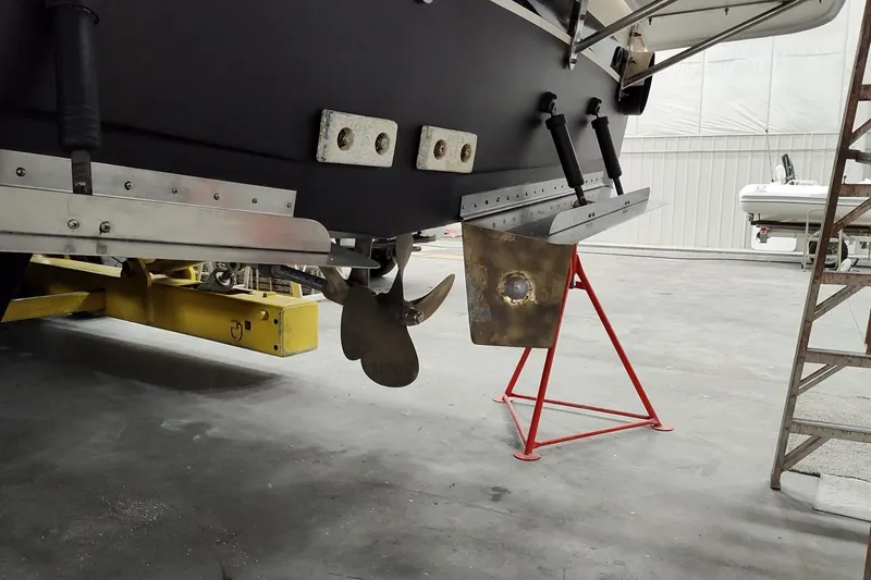  Yacht Photos Pics 1990 Jefferson 52 Marquessa ED boat propeller and rudder in a maintenance facility.