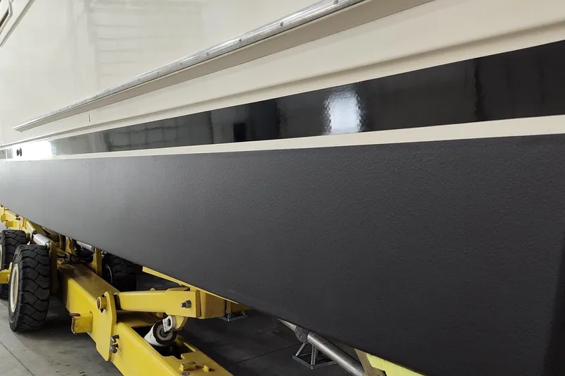  Yacht Photos Pics 1990 Jefferson 52 Marquessa ED yacht on yellow trailer in a garage.