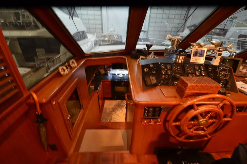  Yacht Photos Pics Interior view of 1990 Jefferson 52 Marquessa ED yacht helm with wooden steering wheel and control panel.