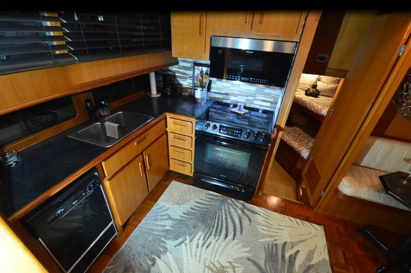  Yacht Photos Pics 1990 Jefferson 52 Marquessa ED yacht kitchen with modern appliances and wood cabinetry.