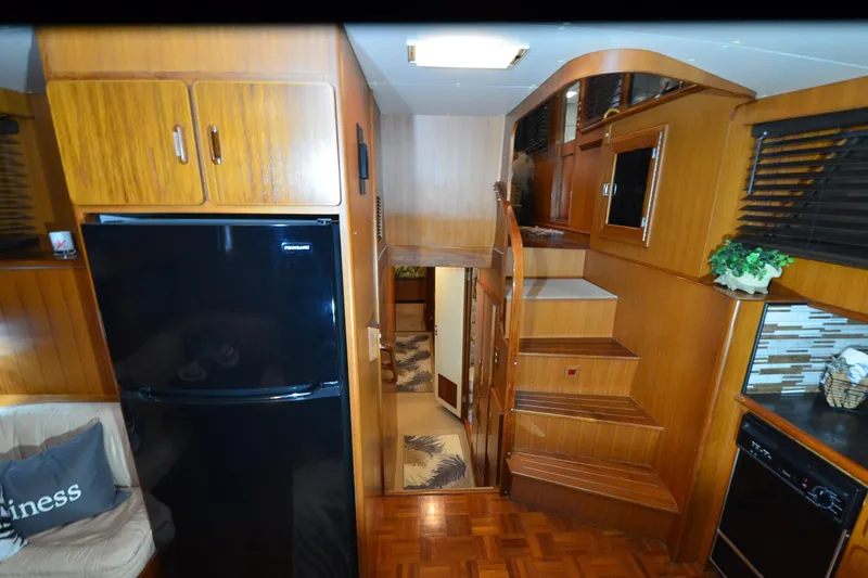  Yacht Photos Pics Interior of a 1990 Jefferson 52 Marquessa ED yacht with wooden cabinetry and modern appliances.