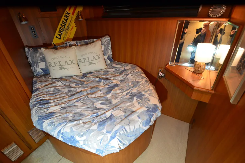  Yacht Photos Pics Cozy bedroom in 1990 Jefferson 52 Marquessa ED yacht with floral bedding and warm lighting.