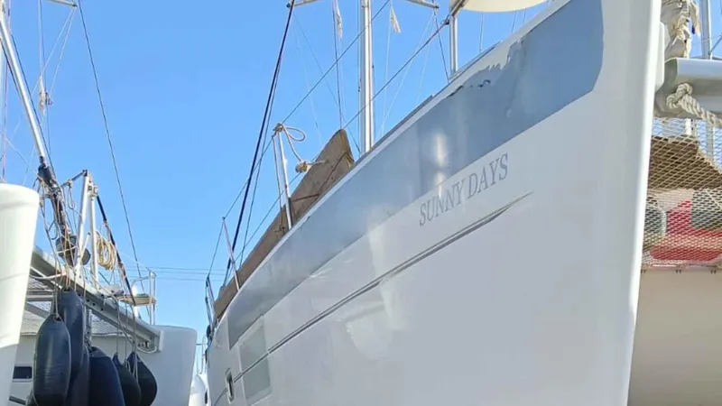 Sunny Days Yacht Photos Pics 2013 Lagoon 380 S2 catamaran named "Sunny Days" docked with clear blue sky.