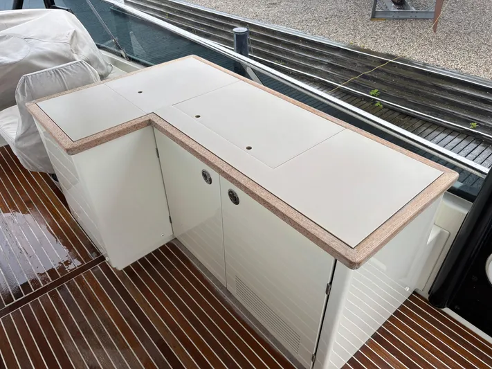  Yacht Photos Pics Beneteau Monte Carlo 6 (2015) yacht deck with sleek white cabinetry and wood flooring.