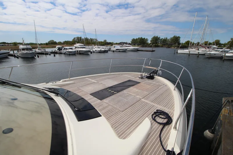  Yacht Photos Pics Bow view of 2015 Beneteau Monte Carlo 6 yacht docked in a marina.