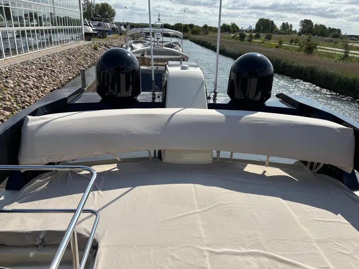  Yacht Photos Pics 2015 Beneteau Monte Carlo 6 yacht on a calm waterway, featuring a spacious deck.