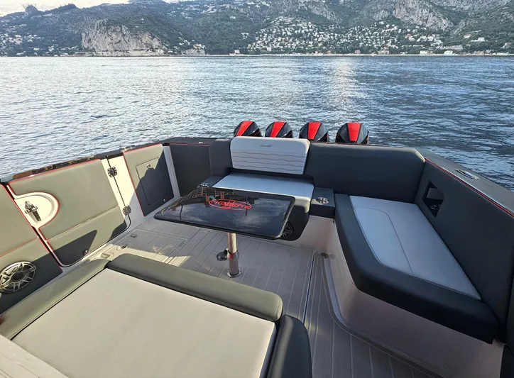 Roman Eagle Yacht Photos Pics 2024 Cigarette 42 Auroris boat interior with seating, table, and scenic ocean view.