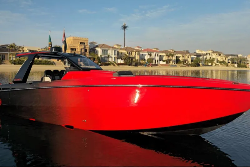 Roman Eagle Yacht Photos Pics 2024 Cigarette 42 Auroris speedboat in vibrant red, docked near luxury waterfront homes.