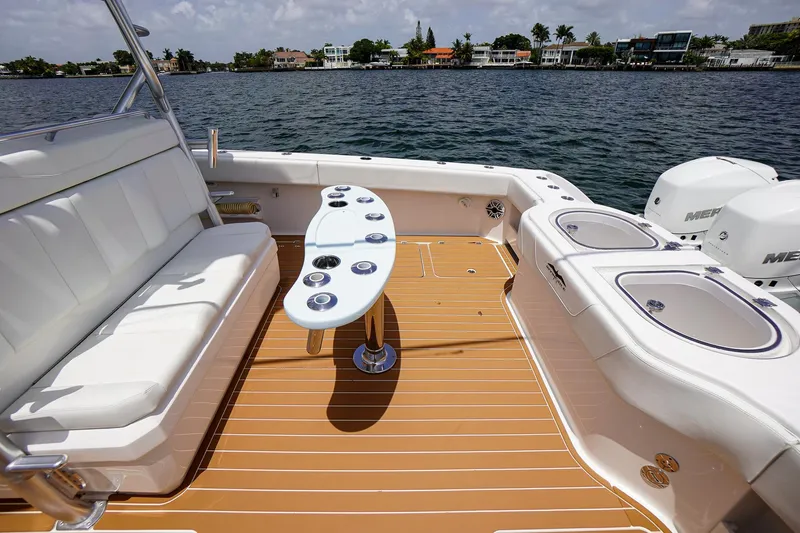  Yacht Photos Pics 2020 Invincible 40 Catamaran deck with seating, table, and ocean view.