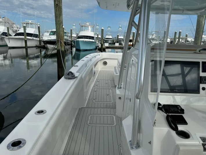  Yacht Photos Pics 2020 Invincible 40 Catamaran docked, showcasing sleek deck design and modern navigation equipment.