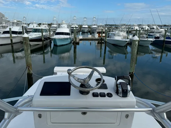  Yacht Photos Pics Helm of 2020 Invincible 40 Catamaran docked in marina with multiple boats.