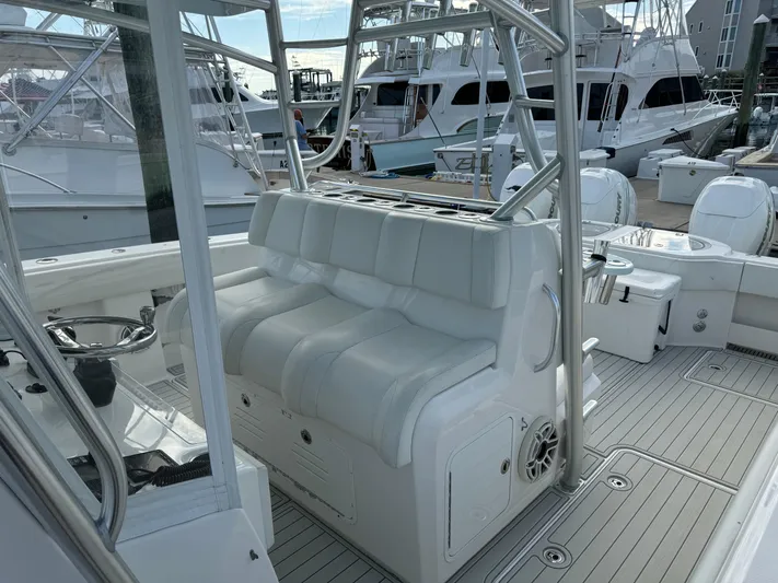  Yacht Photos Pics 2020 Invincible 40 Catamaran interior with white seating and steering wheel, docked at marina.