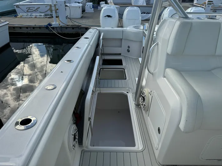  Yacht Photos Pics 2020 Invincible 40 Catamaran deck with storage compartments and seating at marina.