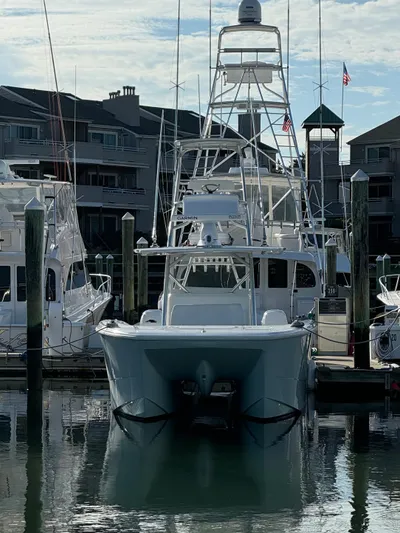  Yacht Photos Pics 2020 Invincible 40 Catamaran docked at marina with residential buildings in background.