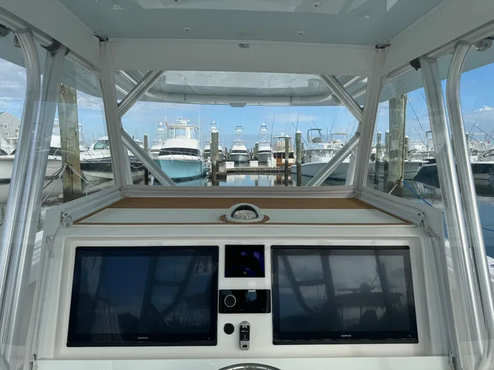  Yacht Photos Pics Helm of 2020 Invincible 40 Catamaran with dual screens, docked at marina.