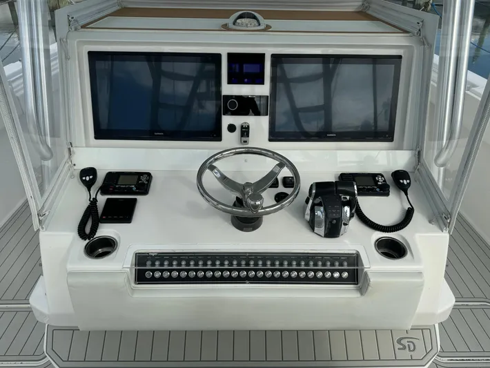  Yacht Photos Pics Control panel of a 2020 Invincible 40 Catamaran with dual screens and steering wheel.
