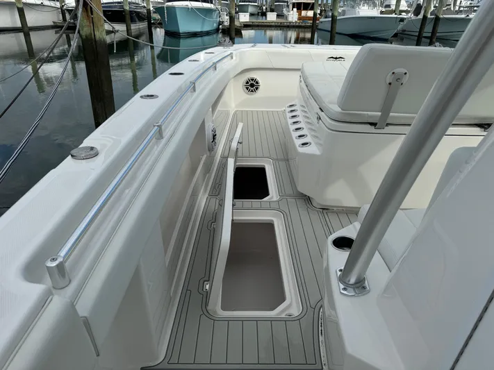  Yacht Photos Pics 2020 Invincible 40 Catamaran deck with open storage compartments in a marina setting.