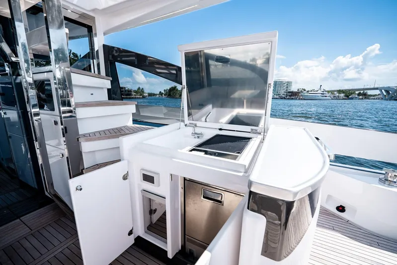 Second Chances Yacht Photos Pics Outdoor kitchen on 2024 Azimut S7 yacht with grill and storage, overlooking serene waters.