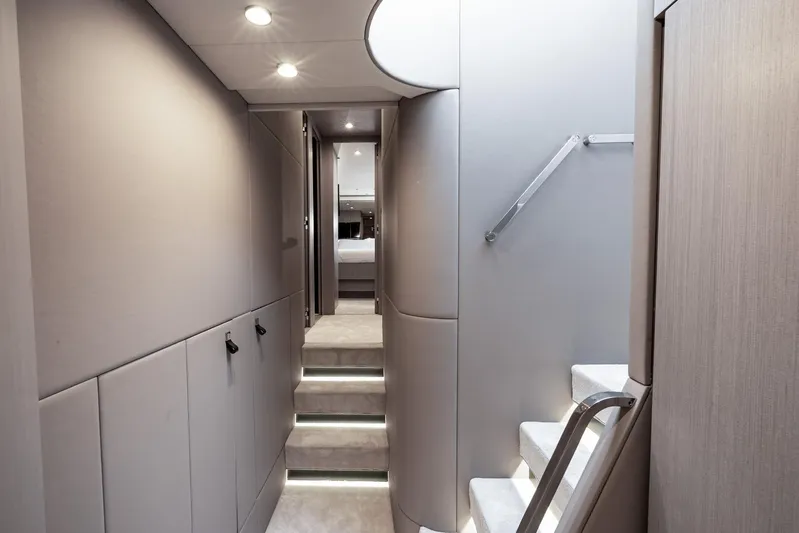 Second Chances Yacht Photos Pics Luxurious interior of 2024 Azimut S7 yacht with modern staircase and ambient lighting.