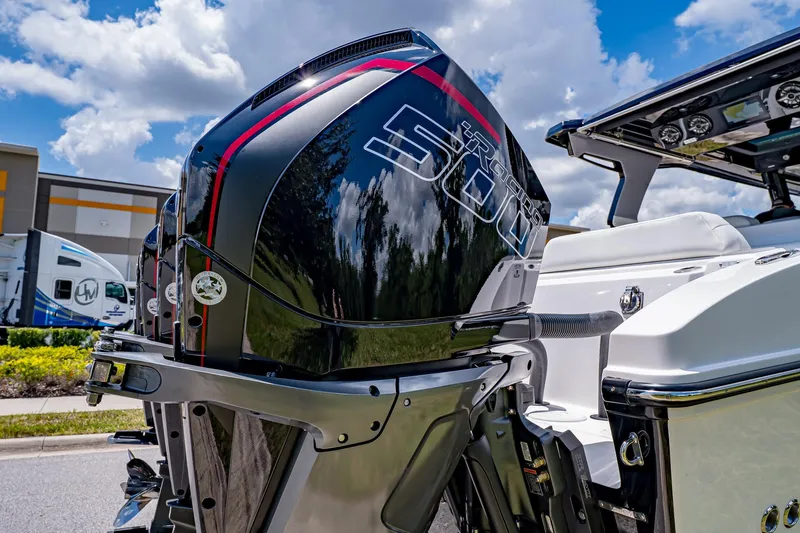  Yacht Photos Pics 2026 Fountain 38 SCX boat with powerful outboard motor, under a bright blue sky.