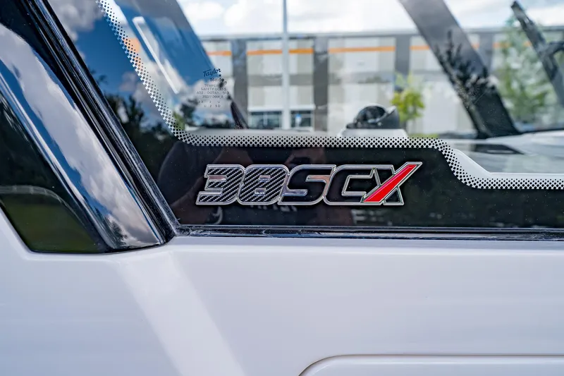  Yacht Photos Pics 2026 Fountain 38 SCX boat logo on window, close-up view.