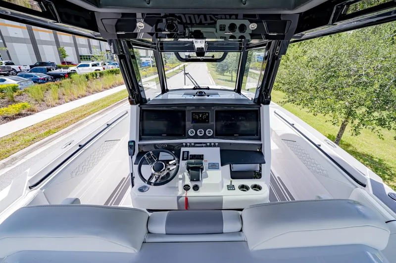  Yacht Photos Pics 2026 Fountain 38 SCX boat cockpit with modern controls and steering wheel.