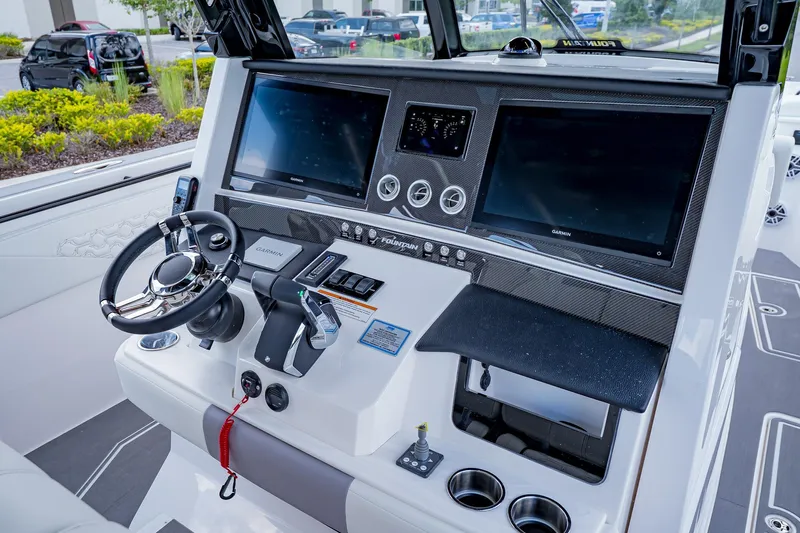  Yacht Photos Pics Helm of 2026 Fountain 38 SCX boat with dual Garmin displays and modern controls.