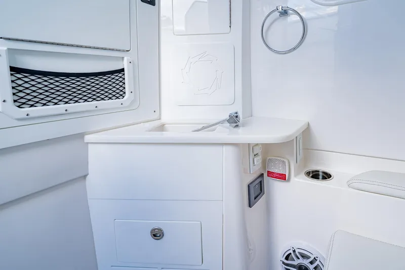  Yacht Photos Pics Interior of 2026 Fountain 38 SCX boat featuring a sleek white sink and storage area.