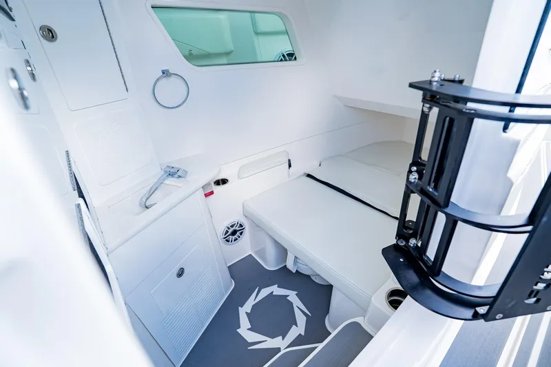  Yacht Photos Pics 2026 Fountain 38 SCX cabin interior with modern white furnishings and compact design.