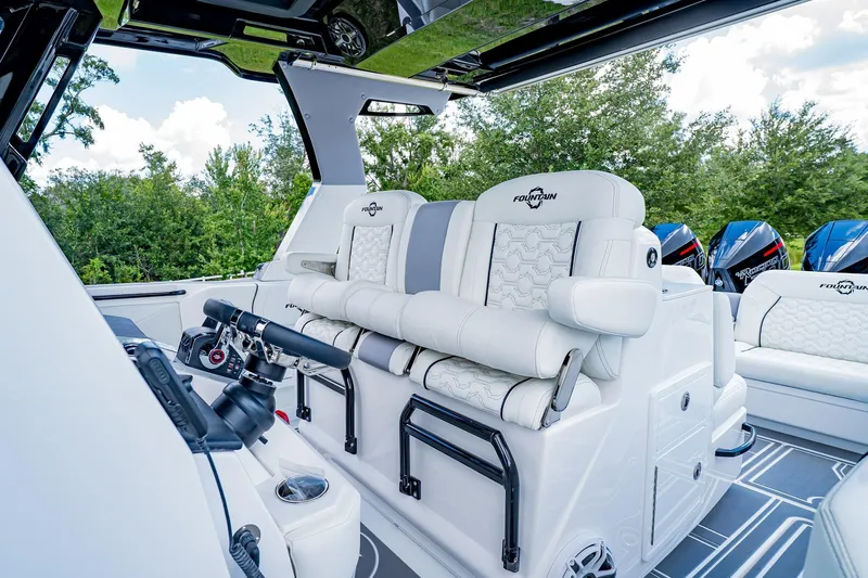  Yacht Photos Pics 2026 Fountain 38 SCX boat interior with luxurious white seating and advanced controls.