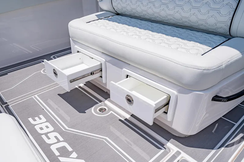  Yacht Photos Pics 2026 Fountain 38 SCX boat interior with open storage drawers and cushioned seating.