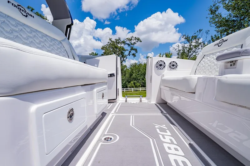  Yacht Photos Pics 2026 Fountain 38 SCX boat interior with white seating and sleek design under blue sky.