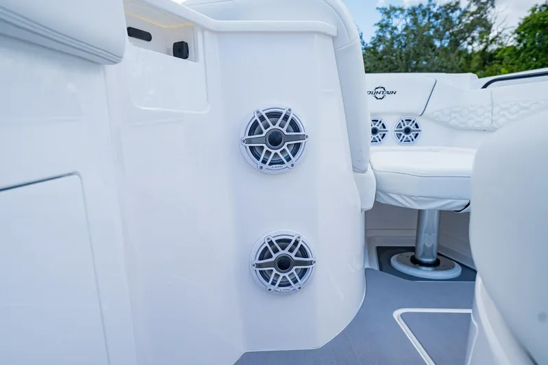  Yacht Photos Pics 2026 Fountain 38 SCX boat interior with speakers and seating, showcasing modern design.