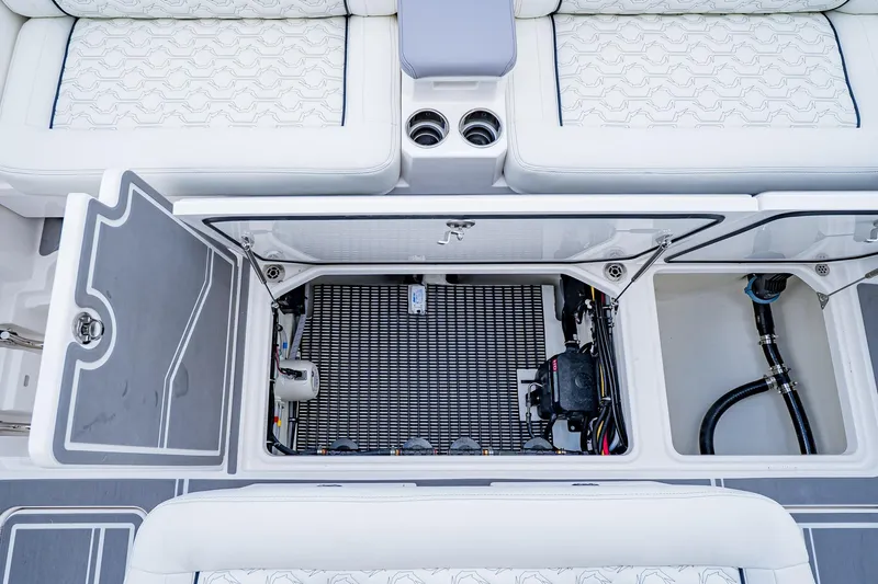  Yacht Photos Pics 2026 Fountain 38 SCX boat interior storage compartment with open hatch and visible wiring.