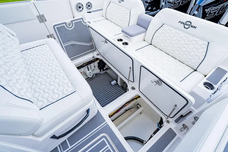  Yacht Photos Pics 2026 Fountain 38 SCX boat interior with open storage compartments and cushioned seating.
