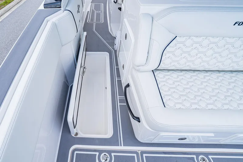  Yacht Photos Pics 2026 Fountain 38 SCX boat interior with white seating and open storage compartment.