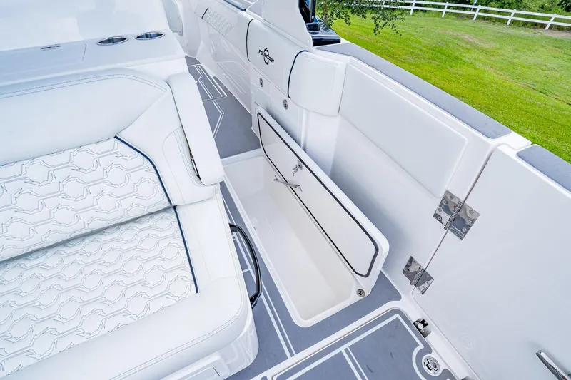  Yacht Photos Pics 2026 Fountain 38 SCX boat interior with white seating and storage compartment.