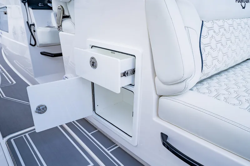  Yacht Photos Pics 2026 Fountain 38 SCX boat interior with open storage compartments and white seating.