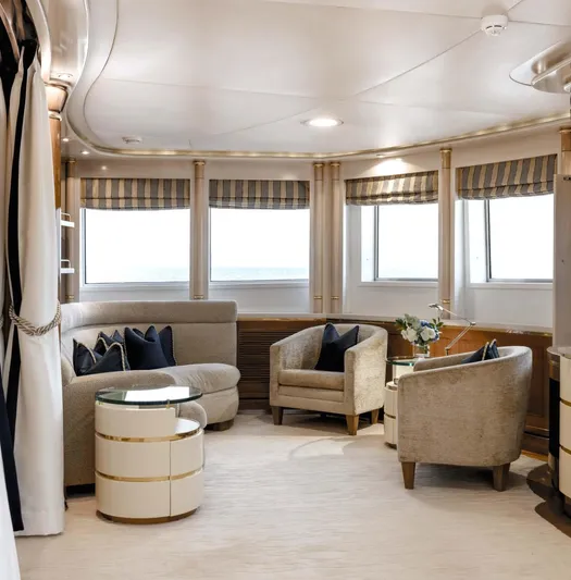 Olympus Yacht Photos Pics Luxurious interior of a 1996 Feadship motor yacht with elegant seating and large windows.