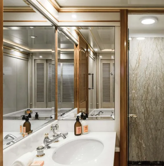 Olympus Yacht Photos Pics Luxurious bathroom on 1996 Feadship motor yacht with elegant fixtures and mirrored cabinetry.