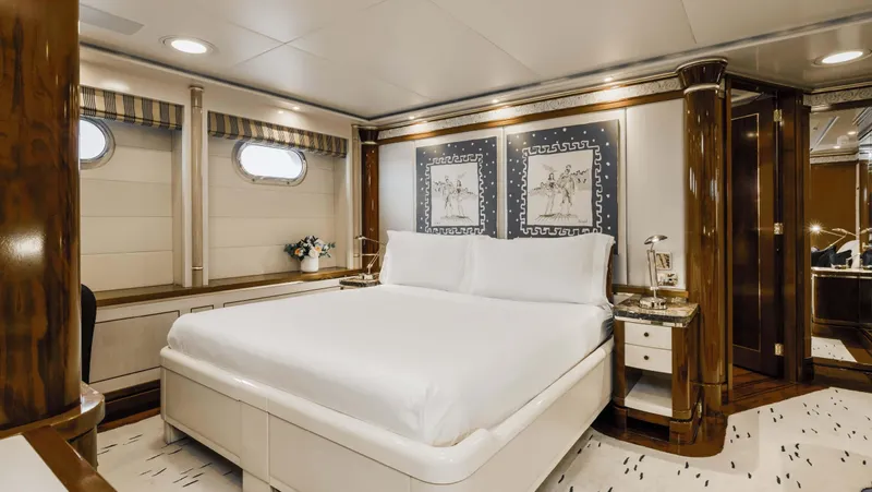 Olympus Yacht Photos Pics Luxurious bedroom interior on 1996 Feadship motor yacht with elegant wood accents and nautical decor.